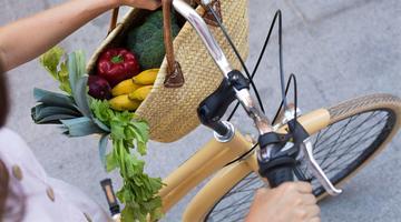 Hands holding bicycle handlebars close up