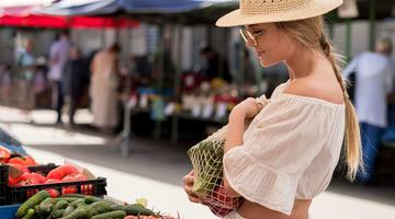 side view woman using organic bag veggies