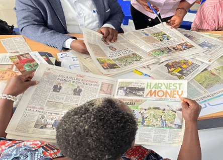A participant in the Fort Portal visioning workshop translates shared priorities into a collective poster. A participant in the Fort Portal visioning workshop translates shared priorities into a collective poster.